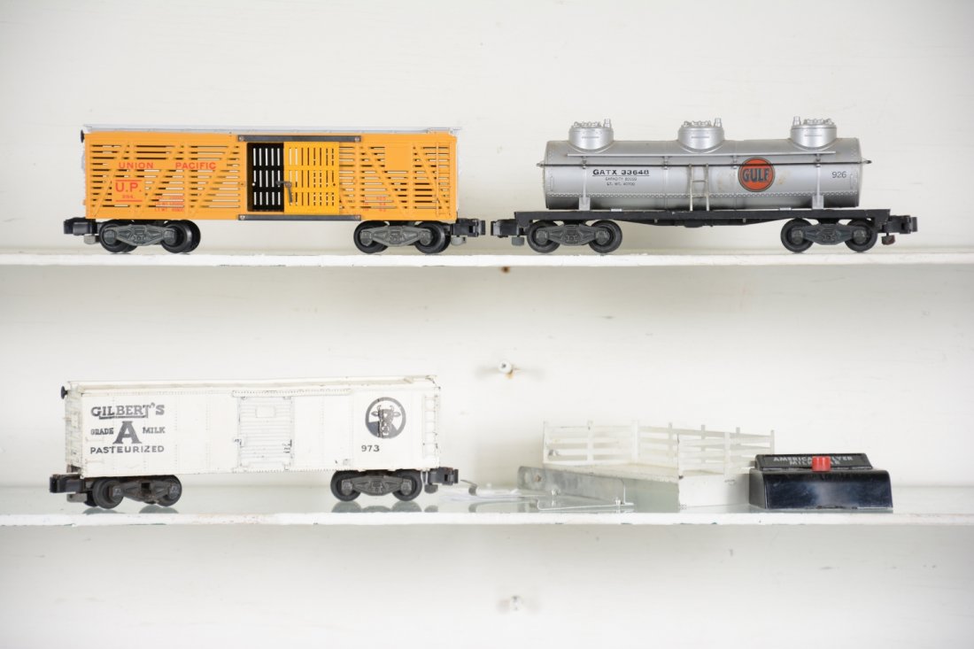 Clean American Flyer Freight Cars: S Gauge. Includes a 973 milk car with platform, activator & controller, no cans; 926 Gulf 3-D tank car; 994 UP stock car. All show light to moderate playwear, C7+-8