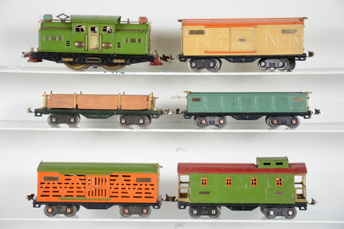 Lionel 318 Freight Set: ST Gauge. Includes a pea green 318 electric, brass wheels, rewired with new lights, ready to run; 511 lumber; 512 gondola; 513 stock car; 514 boxcar; 517 caboose, all are clean, showing light to moder