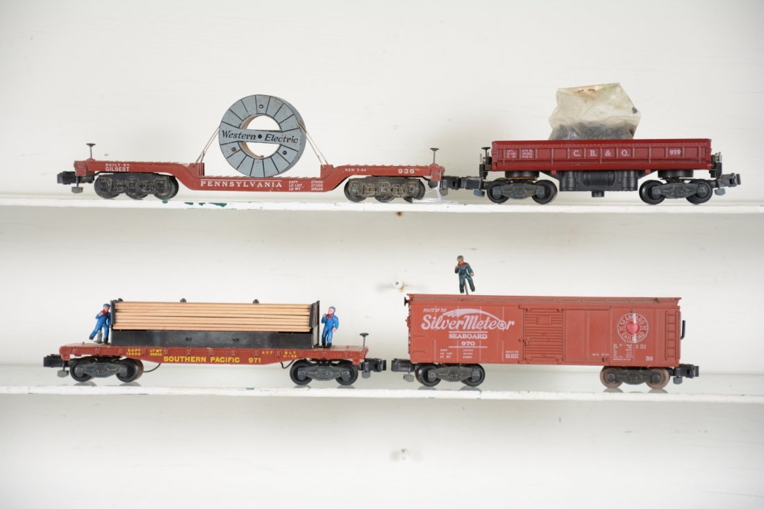 Nice American Flyer Freight Cars: S gauge. Includes a 936 Western Electric reel car; 971 "Moe & Joe" lumber unloading car, replaced figures; 919 coal dump with load; 970 Seaboard operating boxcar. All show light playwear, otherwise C7