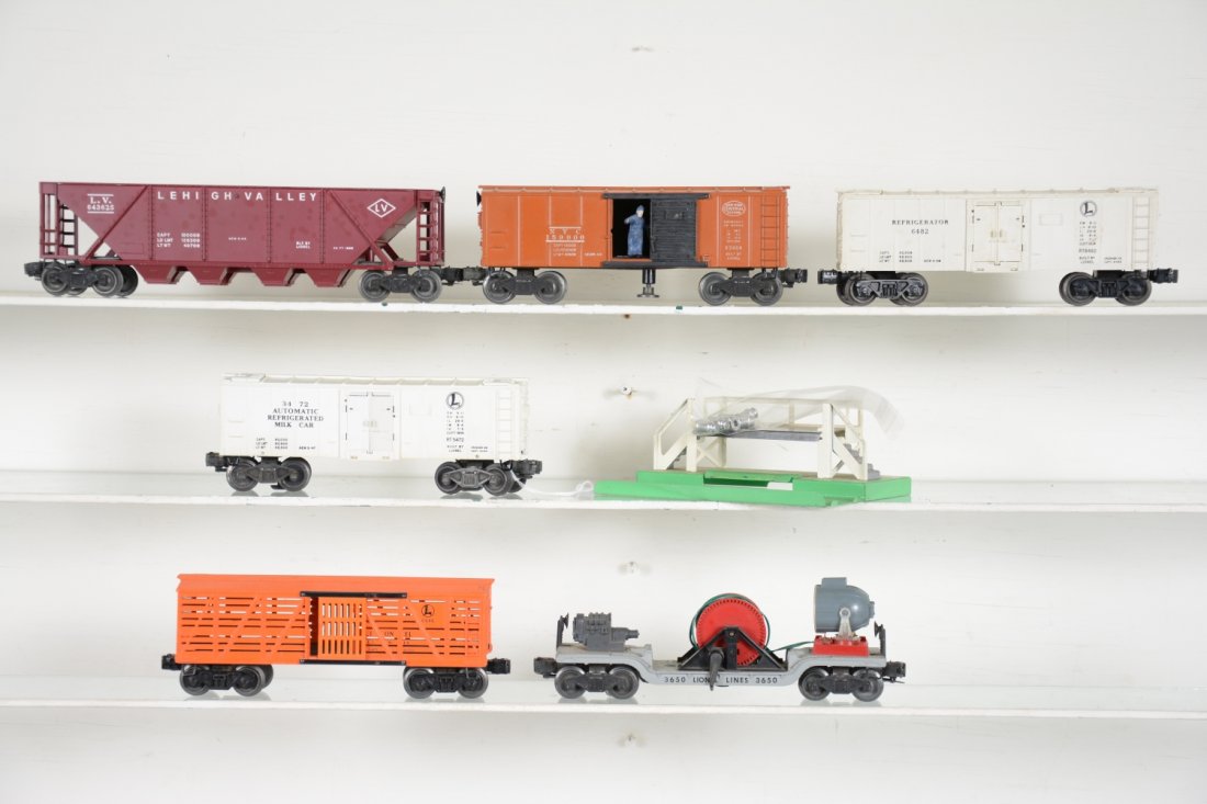 Clean Lionel Freight Cars: Includes a 6646 stock car; 3472 milk car with platform & cans; 6436 LV Quadhopper; 3650 searchlight extension, missing crank; 3464 NYC oper boxcar; 6482 reefer. All show light to moderate playwear, C7
