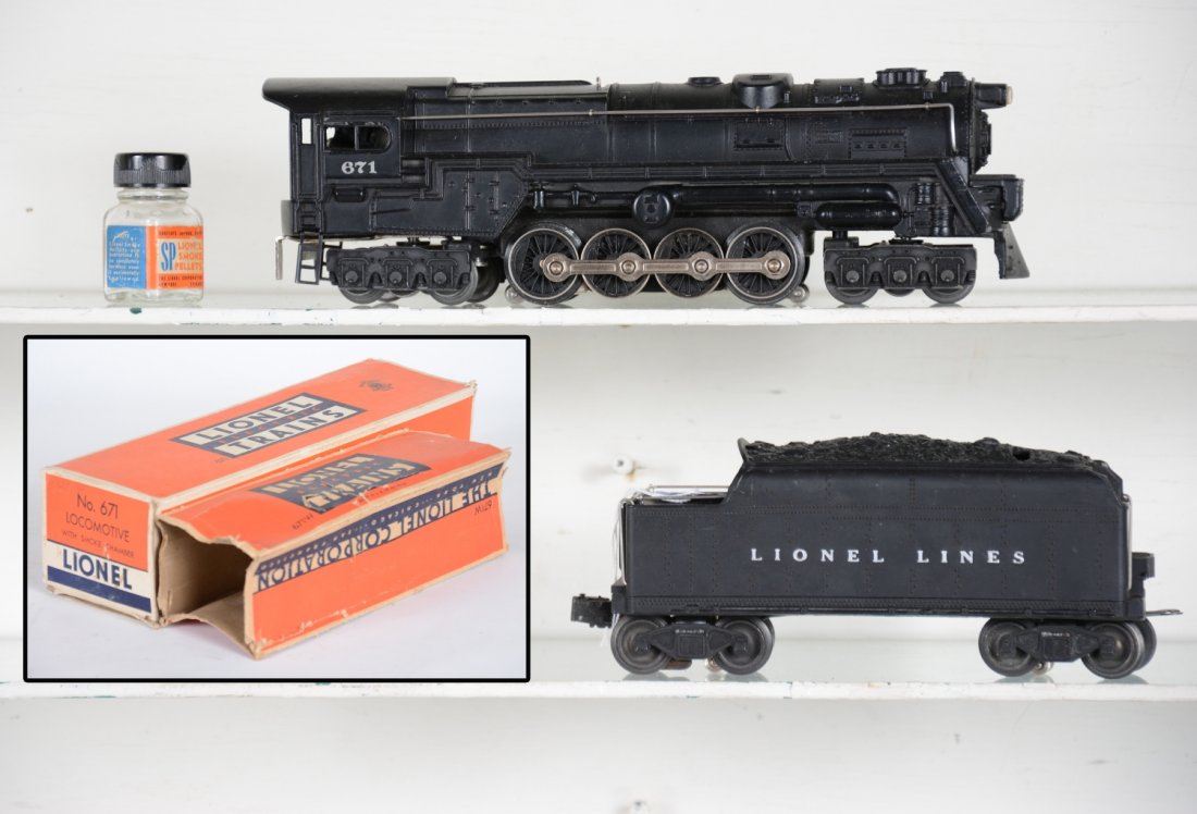 Clean Boxed Lionel PRR 671 Steam Turbine: Nice satin patina with strong cab lettering. Rods are bright, nose decal is 85%; Matching 671W tender. Includes worn loco box with insert and rough tender box. Trains show light playwear, otherwise C7