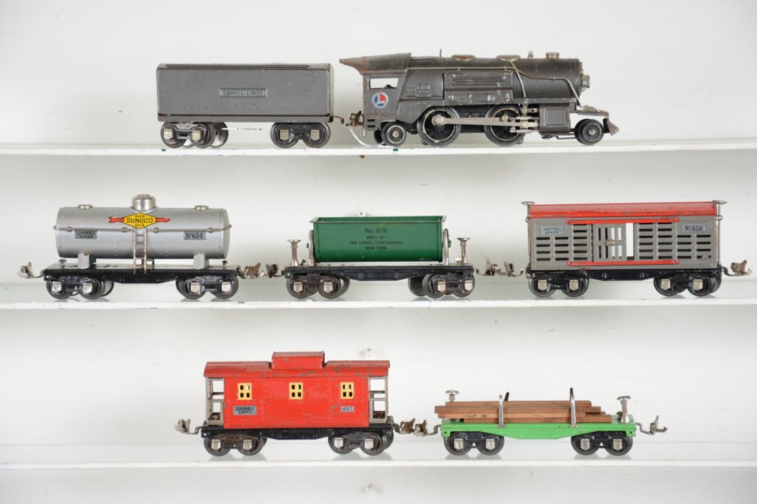Lionel 259E Steam Freight Set: Includes a 259E loco with 1689T tender in gunmetal, C5; 656 stock car; 654 Sunoco tank car; 651 lumber flat, replaced load; 659 tipple dump; 657 caboose. Cars range from light to moderate playwear, C5