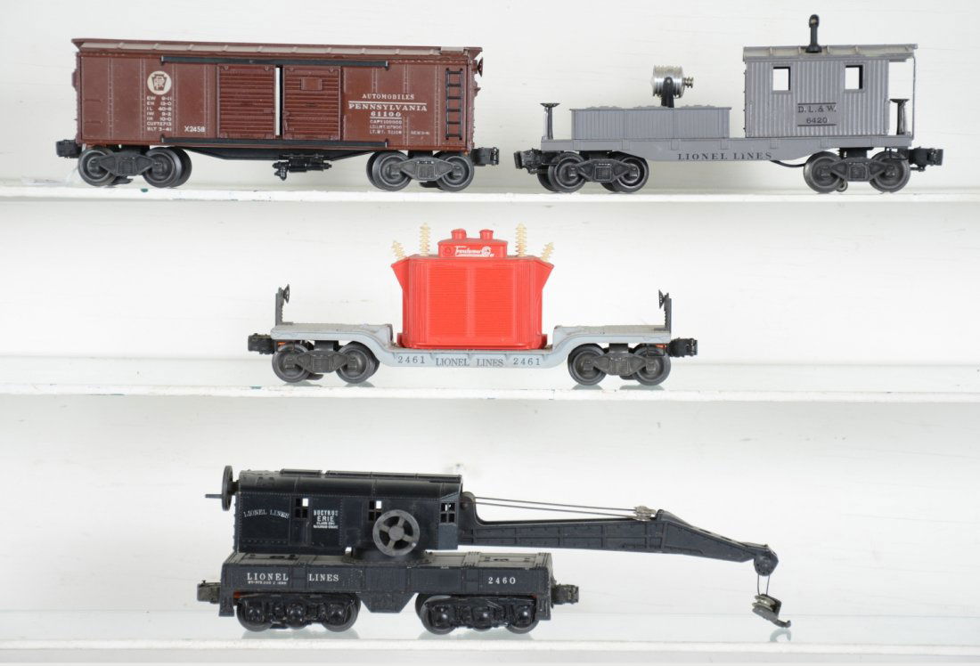 Early Lionel Freight Cars: Includes a LN 6420 searchlight work caboose, C8; 2461 flat with red generator, dusty, C7+; 2458 PRR boxcar, C7; 2460 6-wheel crane, light oxidation on boom support wire, C7