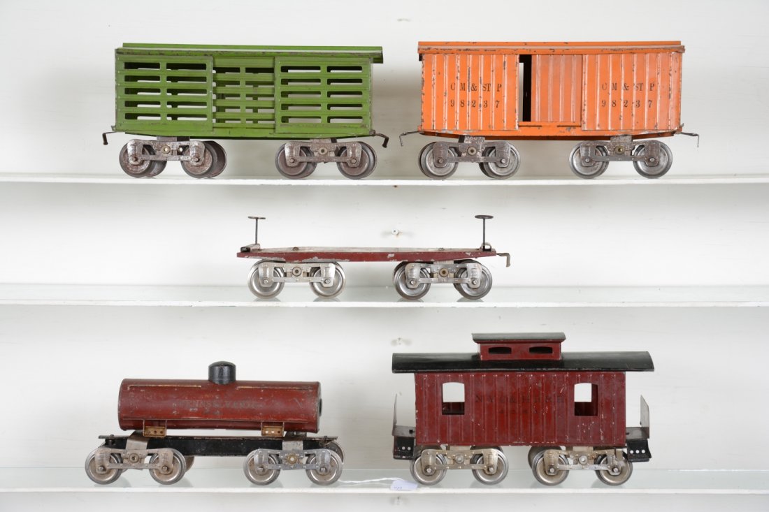 Early Lionel Freight Cars: ST gauge. Includes an 11 flat car; 13 stock car; 15 PRR tank car; 14 boxcar; 17 caboose, 1 loose step, 1 missing. They are fairly clean and show moderate to heavy playwear, C4-6 so examine photos clos