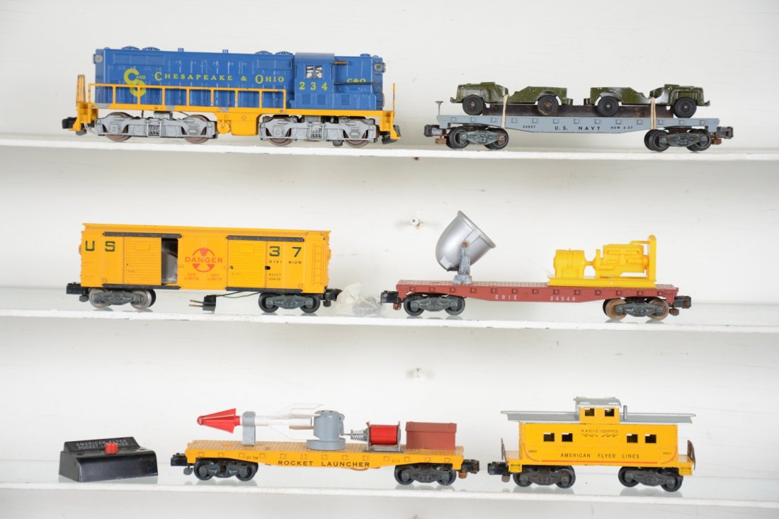 American Flyer (20525) Defender Set: S Gauge. Includes a 21234 C&O GP7 diesel, nice cab, log step frame has 20% flaking; 24557 US Navy flat with jeeps, some oxidation on metal holder; 25056 USM 37 rocket launcher/operating boxcar set wit