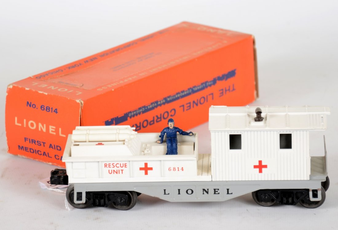 Clean Boxed Lionel 6814 Rescue Caboose: Clean & bright with original accessories. Man figure is loose. It shows light runtime with perf window box with some tape residue. Otherwise, C8