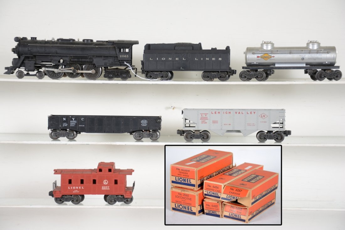 Boxed Lionel 2065 Steam Freight Set: Includes a 2065 4-6-4 locomotive, fairly clean with matching 6026W whistling tender; 6462 gondola; 6465 Sunoco tank car; 6456-25 hopper, light flaking at lettering 1 side, C5; 6257 caboose. All show l