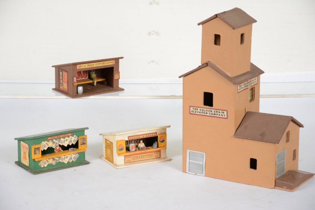 American Flyer 165 & 270 Buildings: S Gauge. 1952 production. Includes a 165 grain elevator, some spider webbing to finish, top section reattached, some loose window inserts; 271 whistle stop set, bus station has burn spot in back, news