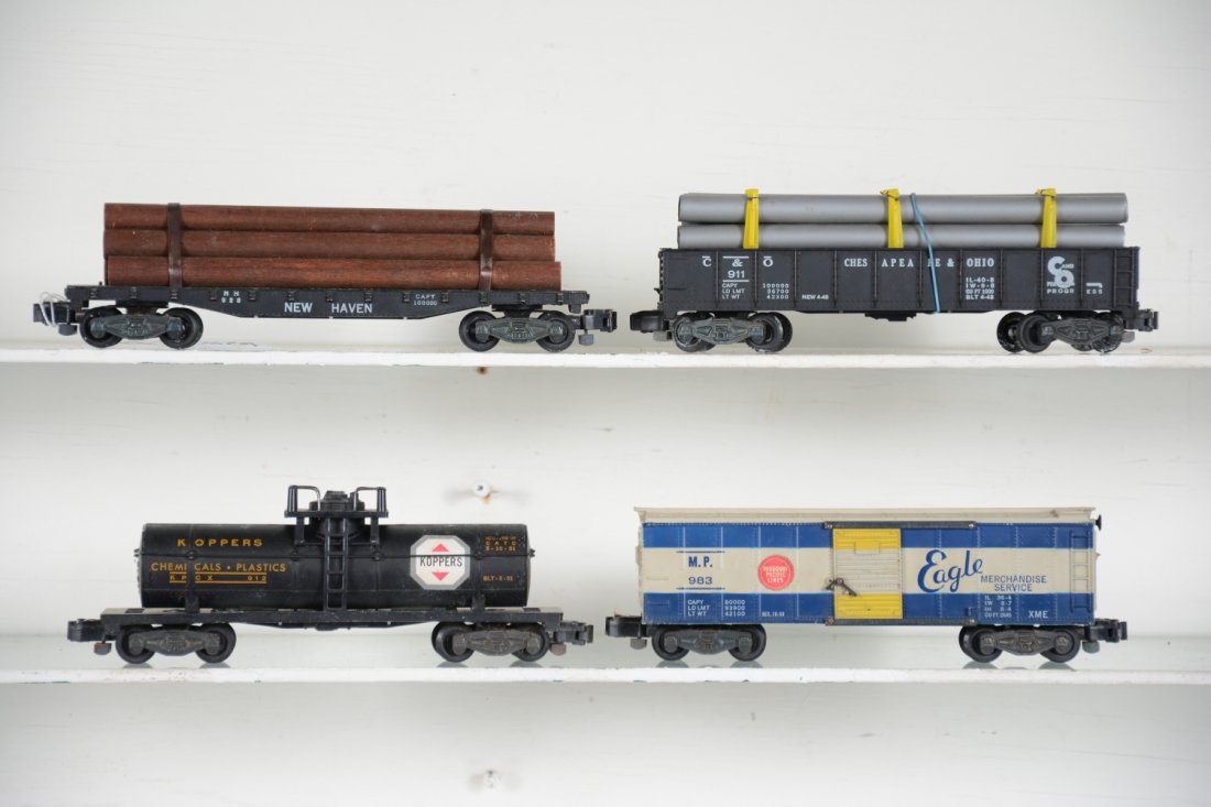 American Flyer Freight Cars: S Gauge. Includes 983 MP boxcar; 926 log car; 912 Koppers tank car, light mildew spots; 911 C&O pipe car. All show light playwear, C7+