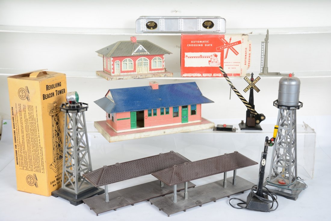 Marx Accessory Lot: Includes a boxed 0446 beacon; boxed 428 crossing gate; 2 Big Rail platforms; bubbling water tank; electric semaphore; electric crossing gate; Big Rail crossing gate; Whistling station, C6; NYC girder 