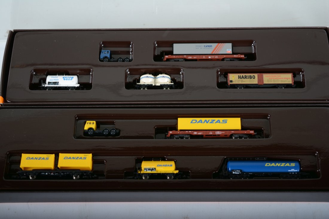 Marklin Z Gauge Freight Car Assortments: Includes a 8697 & 82506 5-pc sets all with flat with trailer, tractor and 3 additional Freight cars. All are new in boxes,. C10