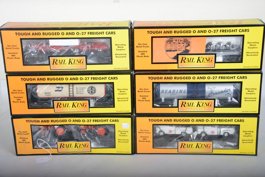 MTH RailKing Freight Cars: Includes 30-73177 Reading tank; 30-7642 flat with Case tractor; 30-7640 flat with tow trucks; 30-7373 Modern tank car; 30-7687 flat with wheel sets; 30-76118 flat with Buicks. All appear new in boxes,