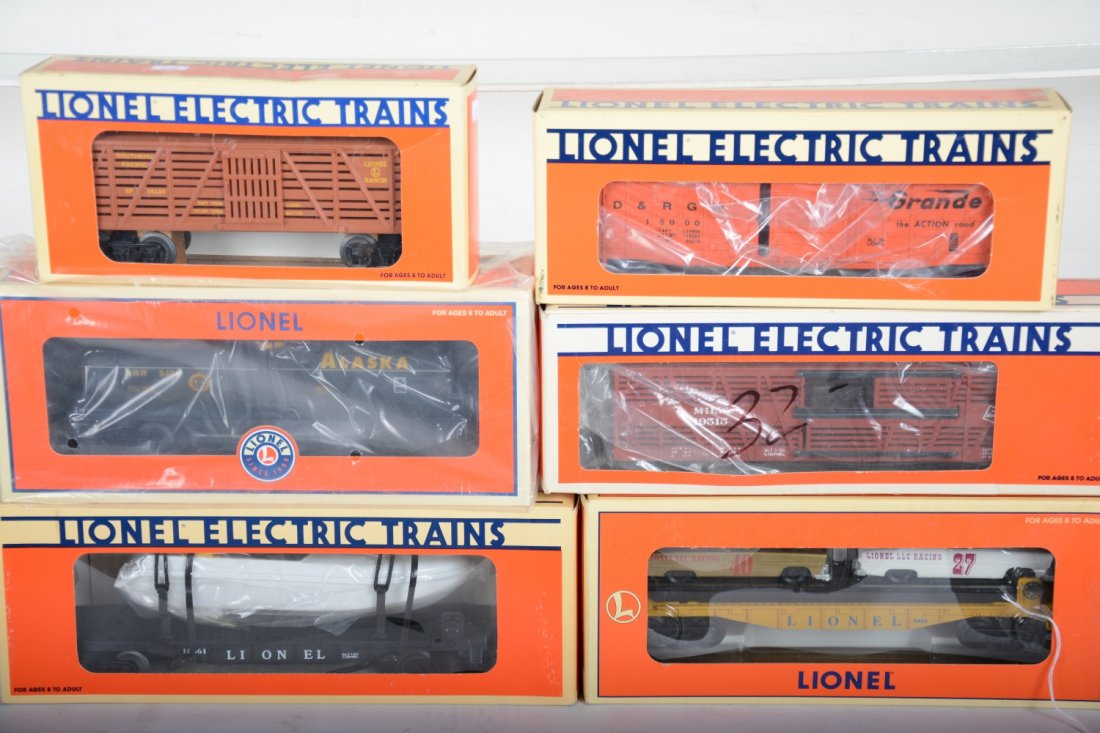 Lionel Freight Cars: Includes 16666 flat with battery boat; 19515 MR stock car; 26171 Alaska tank; 18130 SP stock car; 15000 DRGW waffle boxcar; 19423 flat with stock cars. All appear new in boxes, C10
