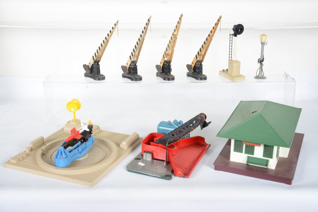 Lionel Postwar Accessories: Includes a 133 station, chimney loose inside; 397 coal loader, no shield, some layout paint; 470 ICBM launcher; 4 #252 crossing gates, some yellowing; 161 block signal; 71 lamppost. All show moderate 