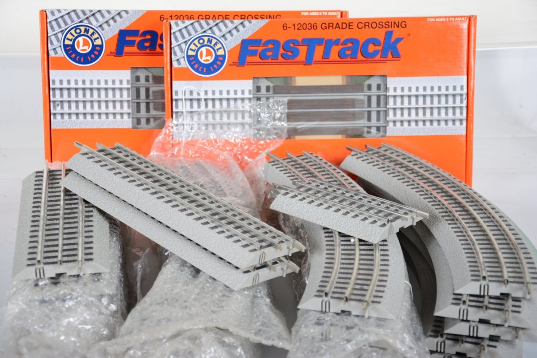 Lionel FasTrack Lot: Includes 2 boxed 12036 grade crossings; 14 -036 curves, minor layout paint overspray on a couple, 5 9" straights; 1 terminal straight; 2- 5" straights; 2 -1.75" straights. Otherwise all are clean and 