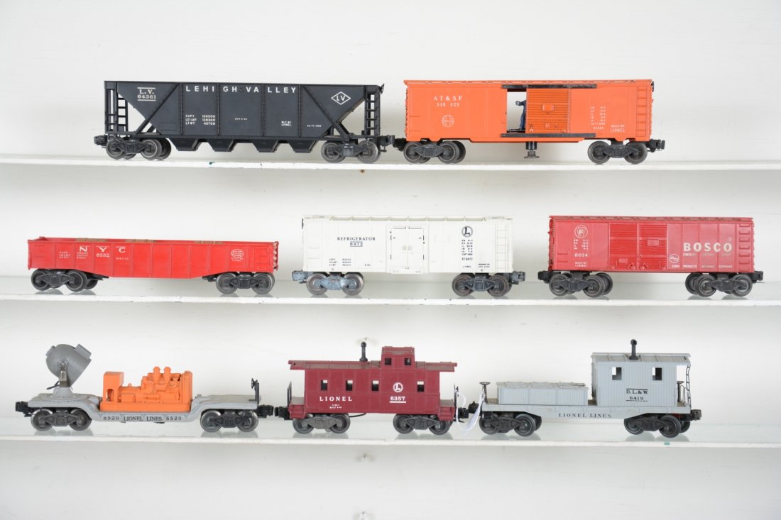 Lionel Rolling Stock Lot: Includes a 6472 reefer 6014 Bosco boxcar; 6357 caboose; 6419 work caboose; 6520 searchlight, missing lens; 6436 LV quadhopper; 3484-25 GN operating boxcar; 6462-125 gondola with 3 barrels. All show li