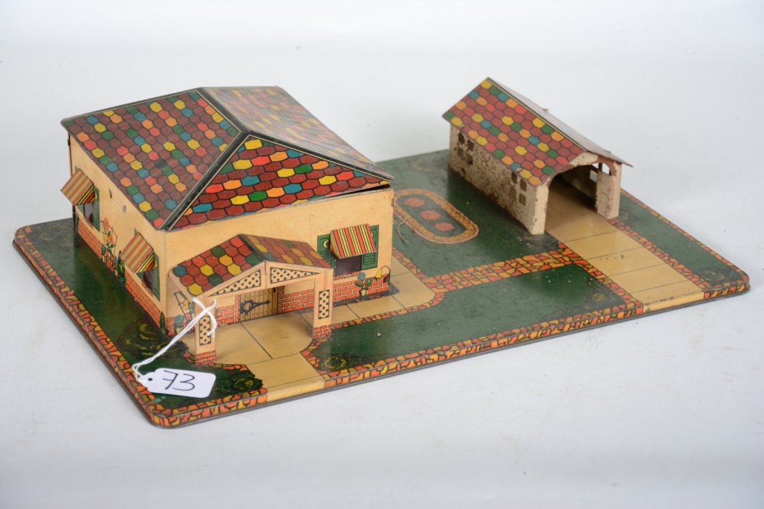 Scarce Marx Bungalow with Furniture: Circa 1930s. Includes a litho tin bungalow on platform with garage, 11 X 17" base. House has interior lighting and litho details with its original set of Miniature TootsieToy cast furniture. It shows 