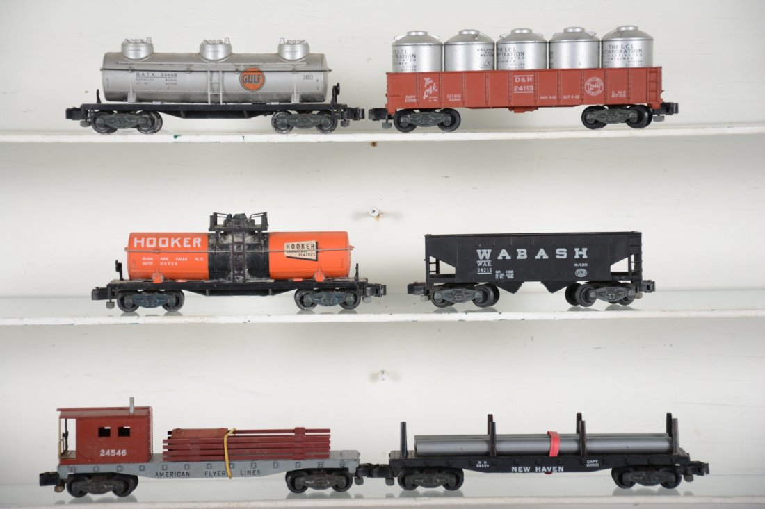 American Flyer 5-Digit Freight Cars: S Gauge. Includes a 24313 Gulf tank, 2 broken steps; 24113 D&H gondola with canisters; 24324 Hooker tank; 24546 work caboose; 24539 pipe flat, missing 1 stake; 24313 Wabash hopper. Rest show light to 