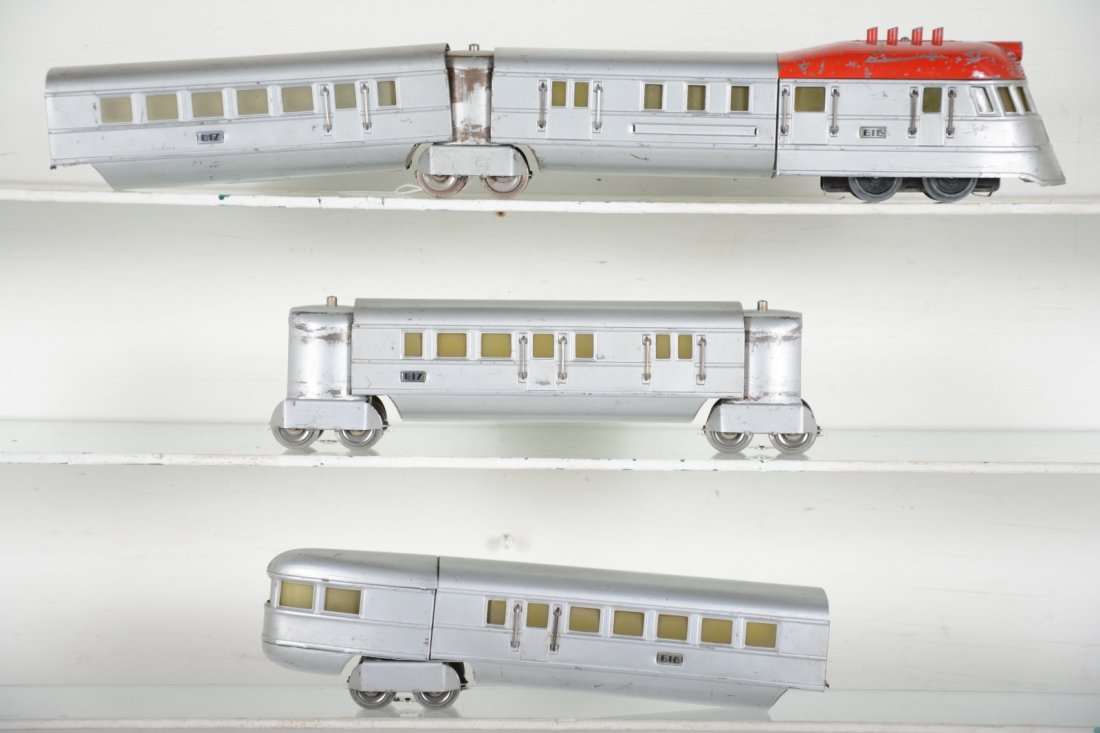 Scarce Lionel 616E Red top Flying Yankee: Circa 1935 uncataloged with non fluted smooth finish; Includes a 616E diesel; 2 #617 coaches, 1 rare double door version; 618 observation. All match in color, are clean with usual vestibule wear, miss