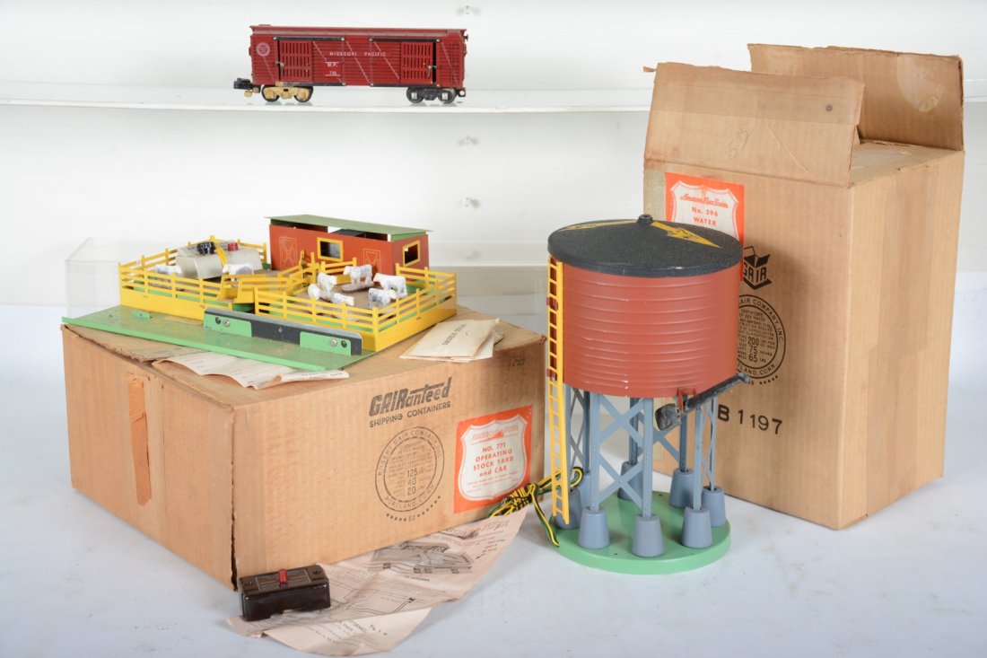 Boxed American Flyer 596 & 771K Accessories: S Gauge. Includes a 771 stock yard with 736 car, 1 conversion coupler, missing other. Has cows and controller with ob & 1 insert; 596 water tank, roof decal flaking 15% with controller and box. They s
