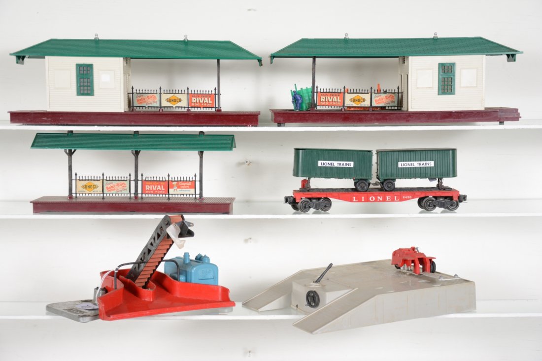 Lionel Accessory Lot: Includes a 356 operating Freight station, missing stickers; 257 station platform; 256 Freight station; 397 coal loader, shield incomplete; 460 piggy-back transportation set, platform missing 1 wheel s