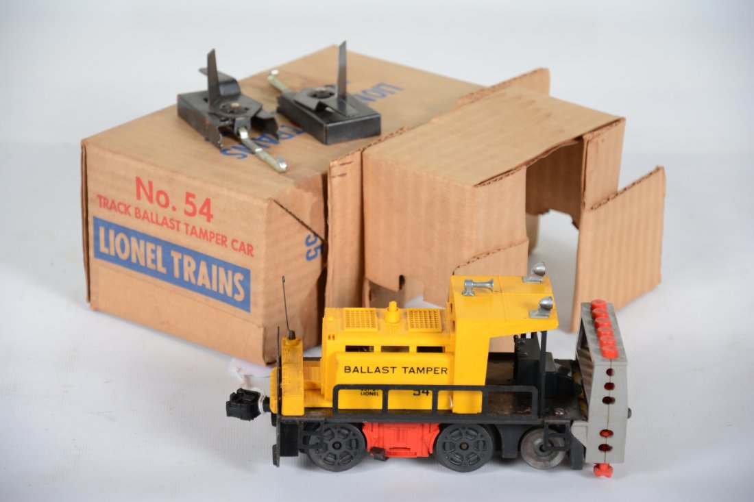 Boxed Lionel 54 Ballast Tamper: Cute motorized unit. It is clean with both track trips. It has been test run, but has oxidation spots on frame. It has a stained box with insert and shows light wear, C8ish
