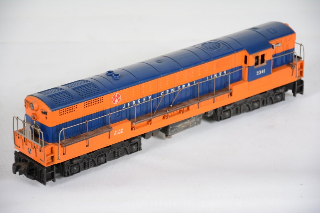 Lionel 2341 JC FM Diesel: Scarce 1957 Only production. This deal motor diesel has an original shell with nice decals. It has moderate battery damage in & out, but surface on frame only. There is a stain on cab window and handr