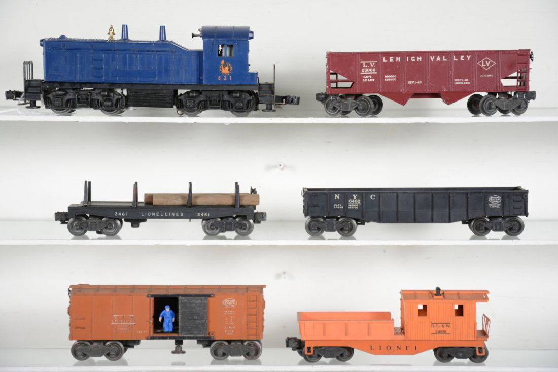 Lionel 621 Diesel Freight Set: Includes a 621 JC NW-2 diesel with horn. Clean with hairline screw crack above screw as well. 6456 LV hopper; 3461 log dump car; 6462 gondola; 3464 NYC operating boxcar, new figure; 6119-25 work caboo
