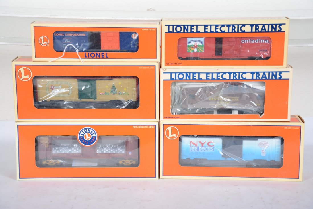 Lionel Freight Cars: Includes 26706 Christmas car with lights; 16767 NYC Ice car; 52299 Vegas Mint car; 19807PRR smoke caboose; 16245 Contadina boxcar; 29200 RRC boxcar. All appear new in boxes, C10