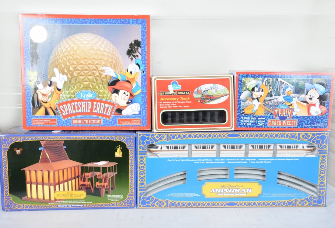 Disney Monorail Play Set, Plus: Build a Disney theme park! Includes a 52 5-car monorail set with track, battery operated; Space Ship Earth attraction; Polynesian hotel; 2 Disney train track accessory packs. All appear new in boxes, 