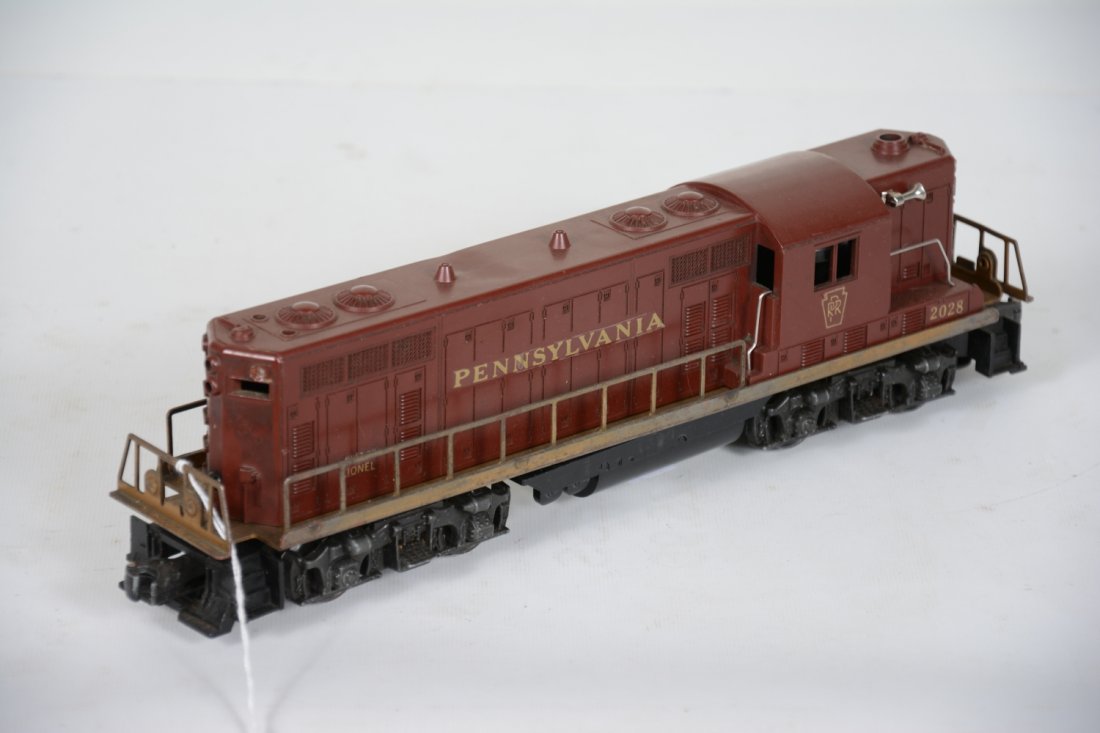 Lionel 2028 PRR GP7 Diesel: Clean shell with decaled lettering and light melt mark one side. Frame is dirty with clean battery box. It show moderate playwear, C5-6