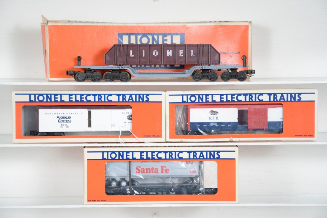 Lionel Freight Cars: Includes 6509 cast girder car; 17502 flat with trailer; 19503 B&A reefer; 5714 MC reefer. All appear unrun with boxes, flat is worn, C10
