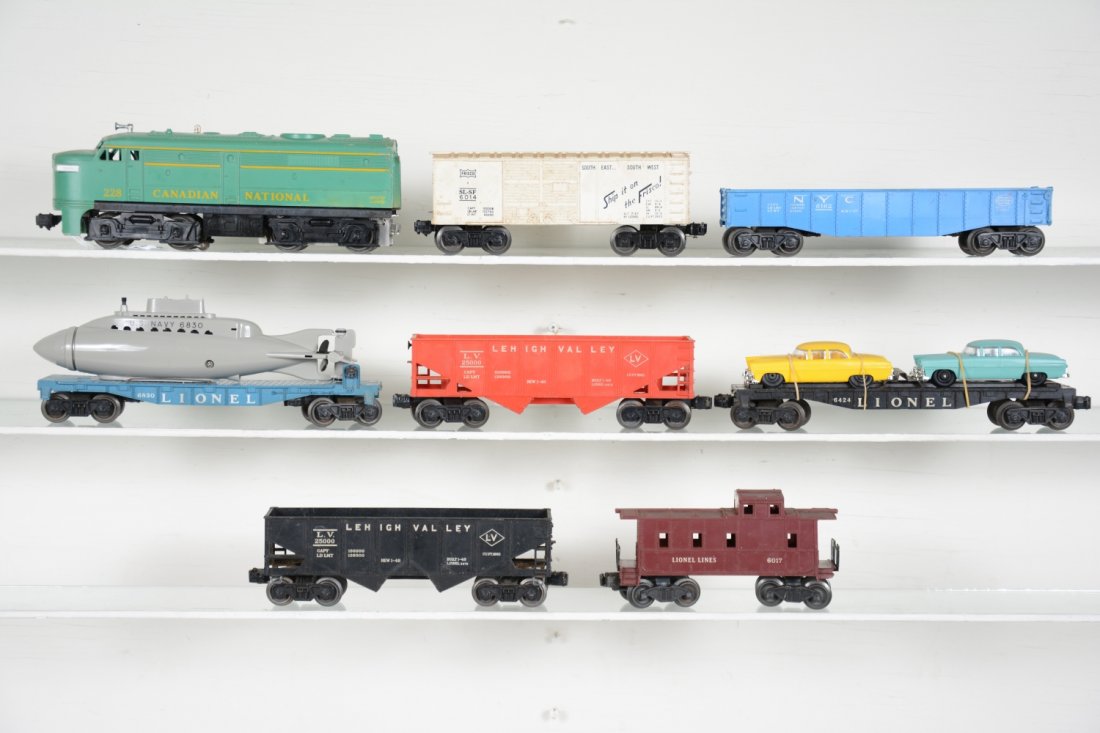 Lionel 228 Diesel Freight Set: Includes a 228 CN Alco A diesel, broken cowl; 6830 flat with repro sub; 6476 LV hopper; 6162 gondola; 6424 auto-loader with repro cars; 6476 LV hopper; 6014 Frisco boxcar; 6017 caboose. All show moder
