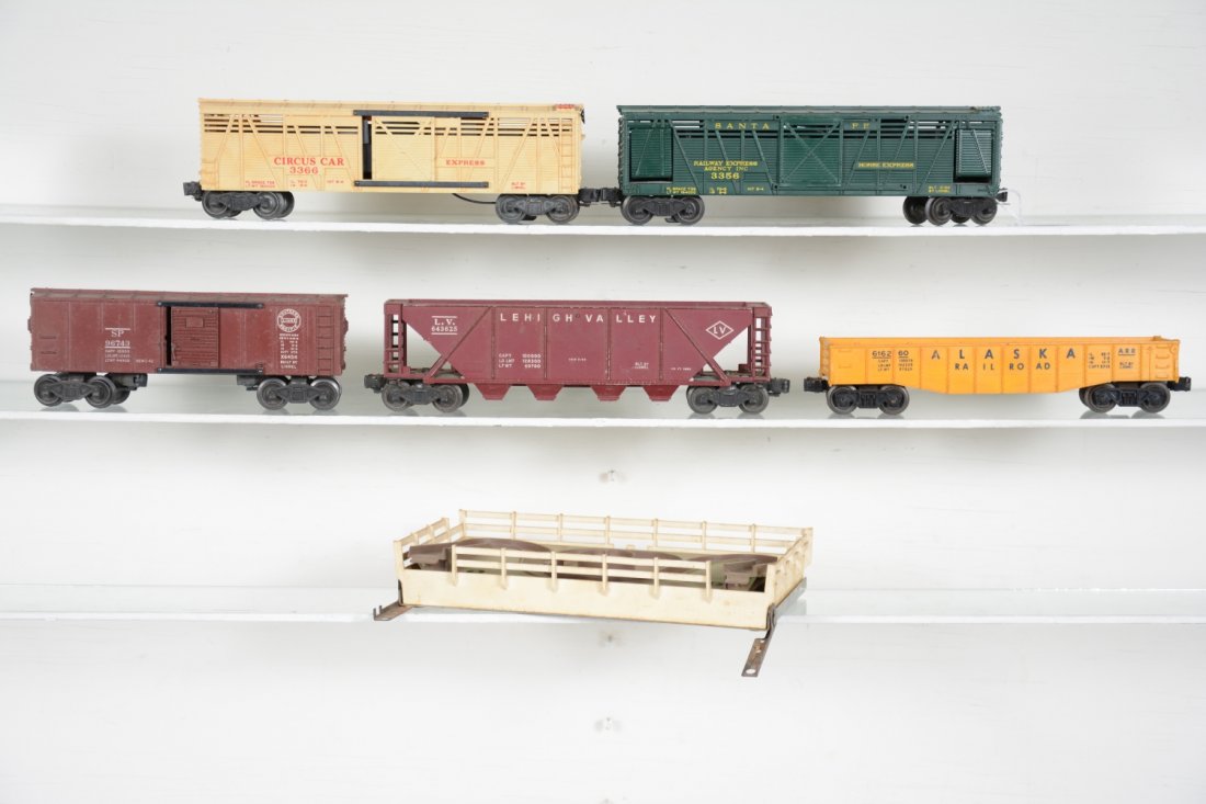Lionel Freight Cars: Includes a 3366 Circus car only, yellowed evenly; 6162-60 Alaska gondola, no canisters; 6346 LV hopper; 6454 SP boxcar; 3356 horse car with coral, some railing issues. All show moderate to heavy playw