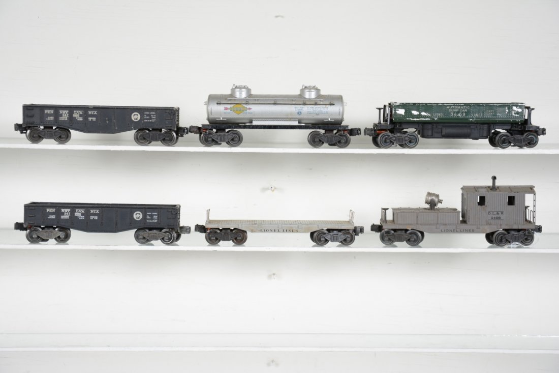 Early Lionel Freight Cars: Includes a 2420 searchlight work caboose, small edge chips; 2 #2452 gondola; 2411 empty flat car; 3459 coal dump; 2465 Sunoco tank. All show moderate playwear, dirty, C5-6