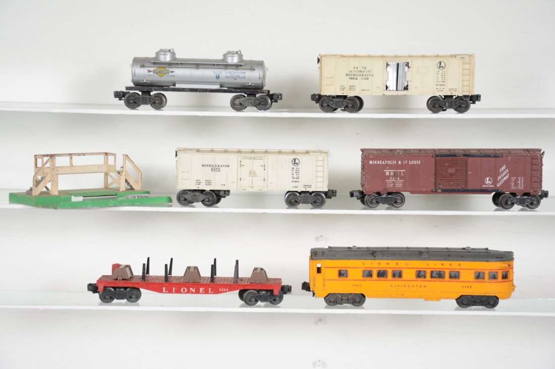 Lionel Freight Cars: Includes 6264 lumber car, no boards; 3672 milk car with platform, has cans, no platform top; 6464-50 M&StL boxcar, type I, C4; 6472 reefer; 2483 Livingston observation, C5; 2465 tank car. Rest show mo