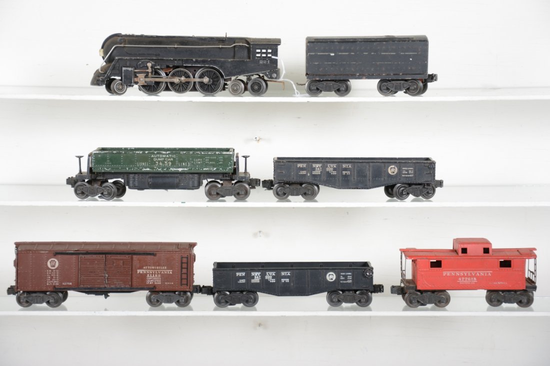 Lionel 221 Steam Freight Set: Includes a 221 Dreyfus Hudson loco; 221T tender, 2% decals; 2458 PRR boxcar, flying shoe trucks; 3459 coal dump; 2 #2452 PRR gondolas; 2472 caboose. All show moderate playwear, rest C5+-6