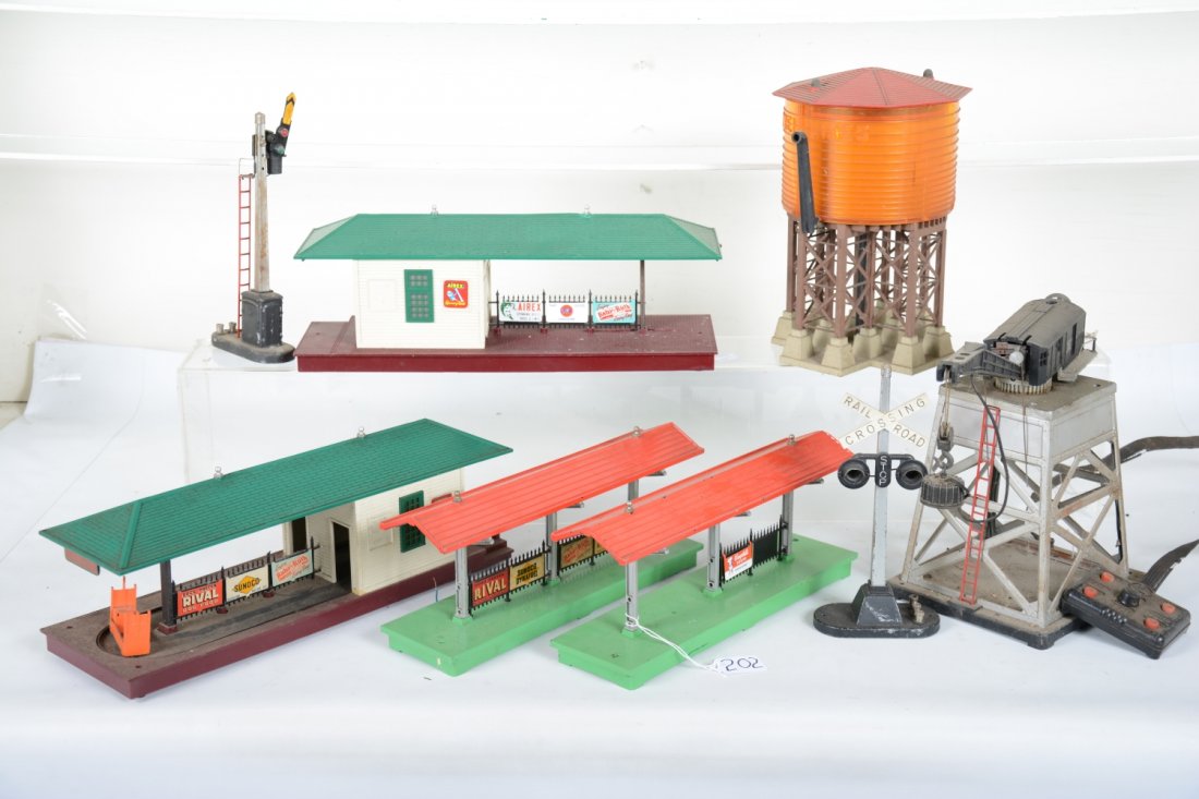 Lionel Accessories Lot: Includes 2 #156 station platforms, 1 has incomplete fence and sigs; 38 pumping water tower, missing finial, roof chipped; 182 magnetic crane, missing stack, needs wiring; 256 Freight station, hairline