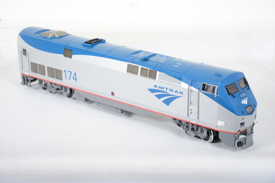 LGB Amtrak 22490 Genesis Diesel: 29" long, clean and detailed. It has a broken front snow plow and coupler. It comes with its foam insert only. It only shows light runtime, otherwise appears C8