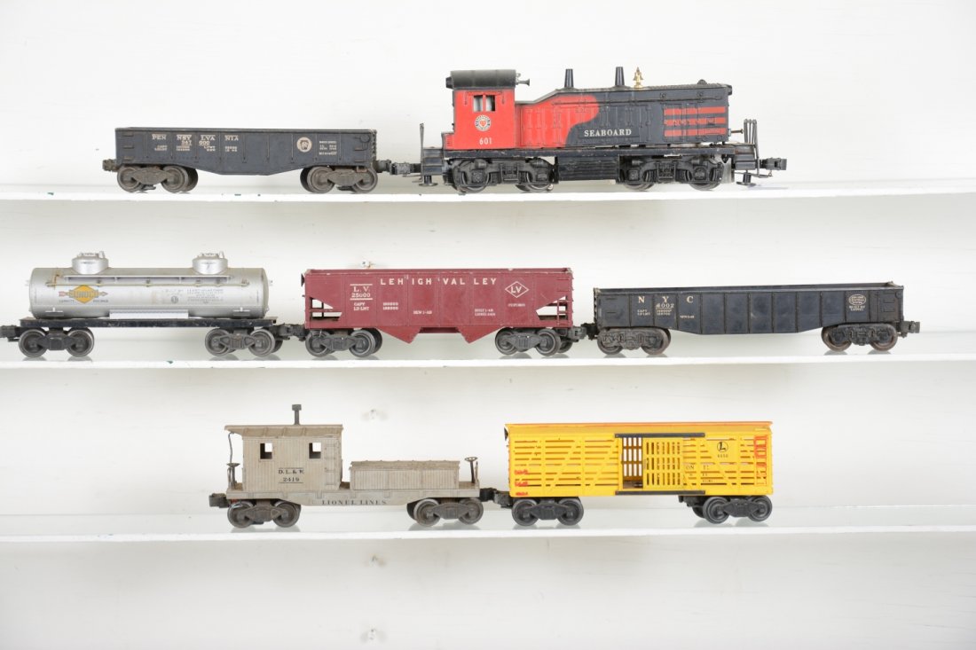 Lionel 601 Diesel Freight Set: Includes a 601 Seaboard NW2 diesel with horn, repaired screw chip; 2452 gondola; 6465 tank car; 6456 LV hopper; 6462 gondola; 6656 stock car, some red paint added; 6419 caboose, chipped. All are dirty