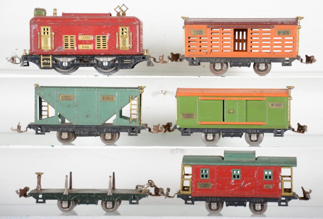 Lionel Pre War 248 Freight Set: Circa 1929. Includes a 248 boxcab electric, wheels fatigued, missing 1 roller pick-up; 803 hopper; 831 flat car, 1 brake stanchion loose(tab intact); 805 boxcar; 8706 stock car; 807 caboose. All match
