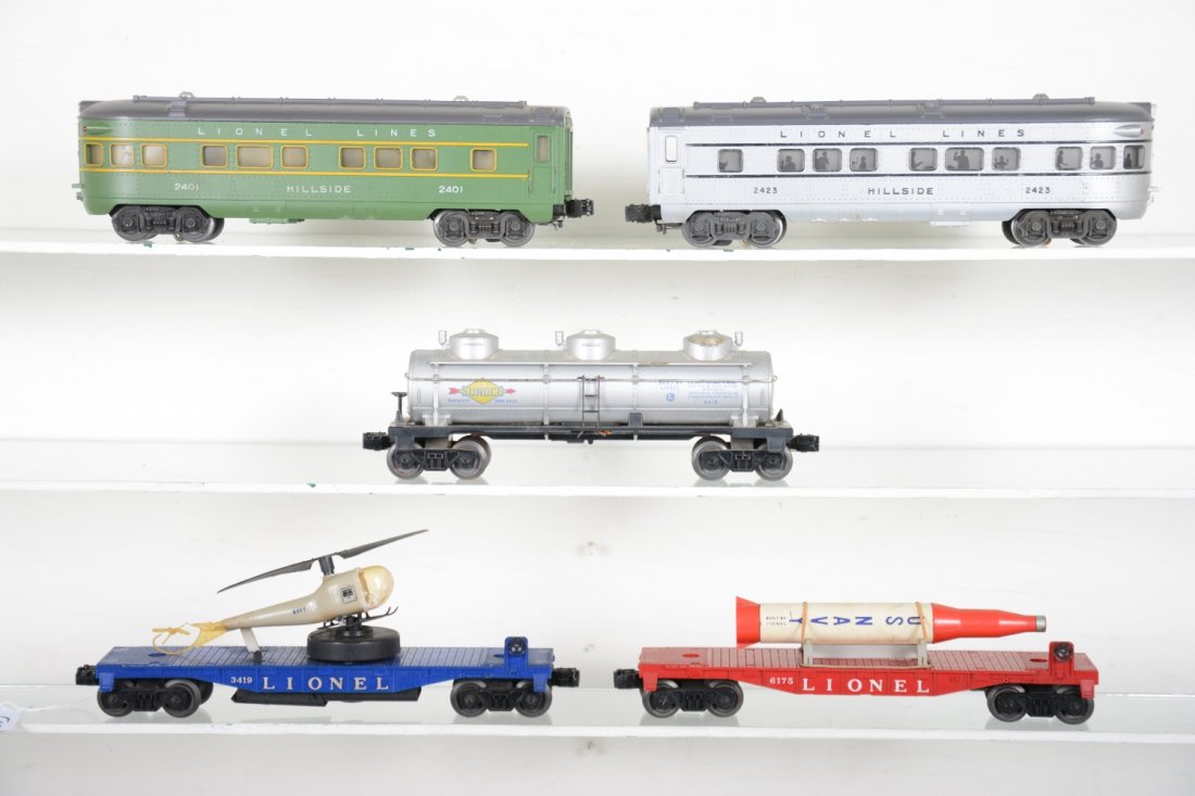 Lionel Rolling Stock: Includes a 2401 Hillside observation; 3419 operating helicopter car, tail loop has split, mildew on bubble; 6175 flat with rocket, missing foam; 6415 tank, tougher with Timken trucks; 2321 Hillside ob
