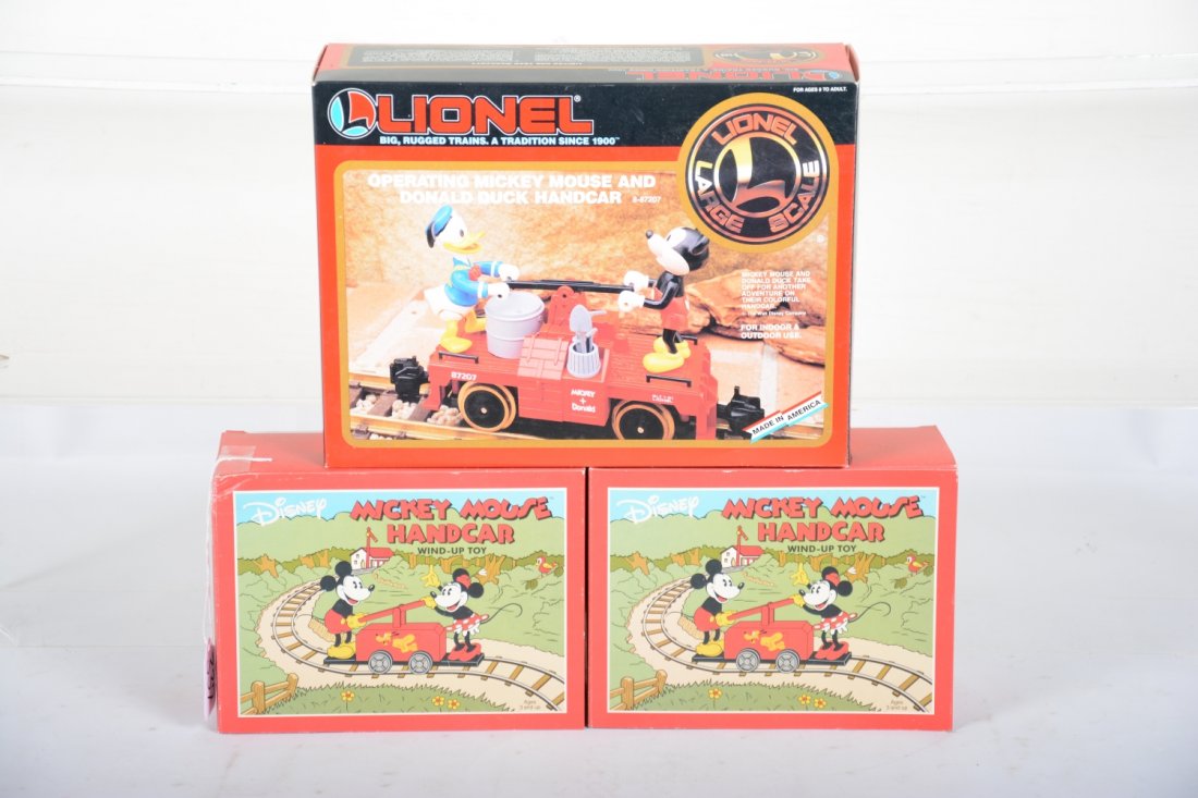 Mickey Mouse Handcar Lot: Includes a Lionel G gauge 87207 Mickey & Donald hand car; 2 Schylling Mickey & Minnie clockwork hand cars. They appear like new with Boxes, C9-10