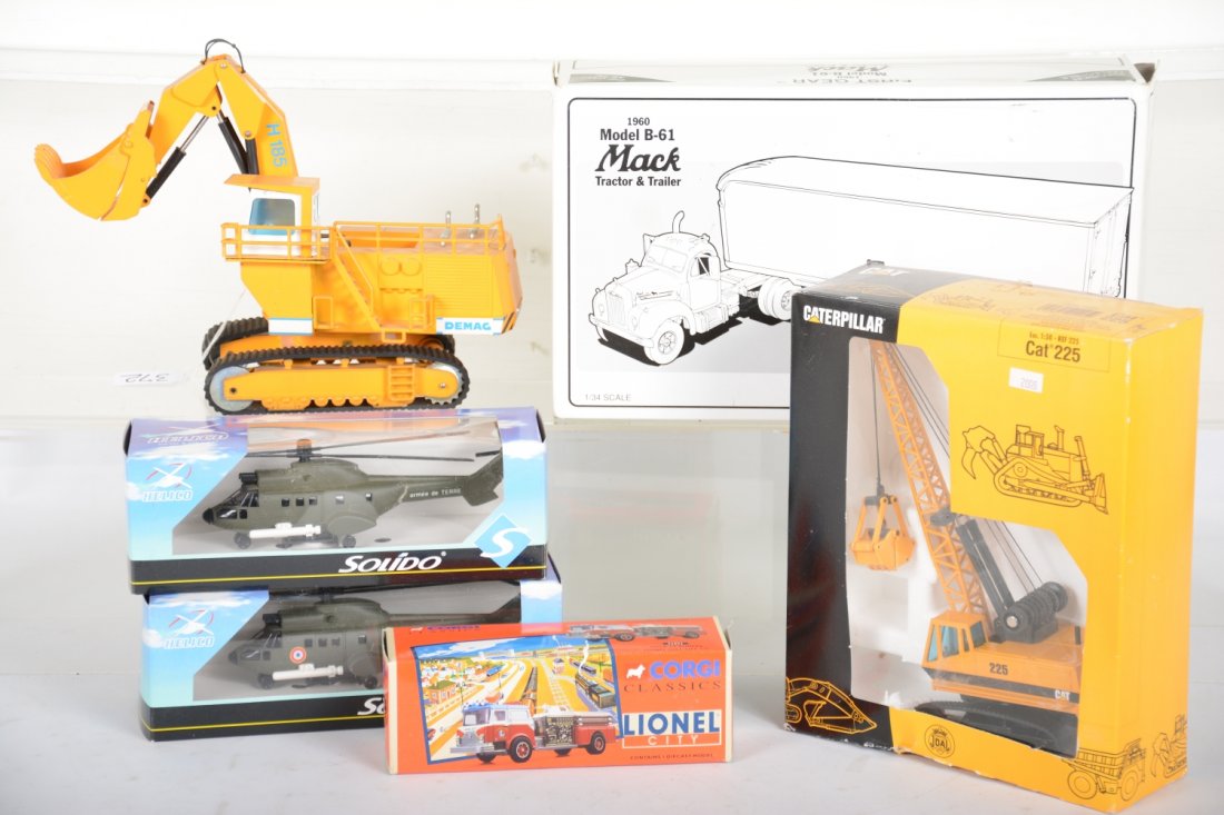 Diecast Toy Lot: Includes a 1st gear Mack B-61 tractor & trailer, ob; NZG 241 DEMAC quarry shovel(1:50), dusty C8; Corgi Lionel fire Truck; 2 Solido Helicopters, obs; Joal Cat 225 crane(1:50), new in box, C10, rest C9