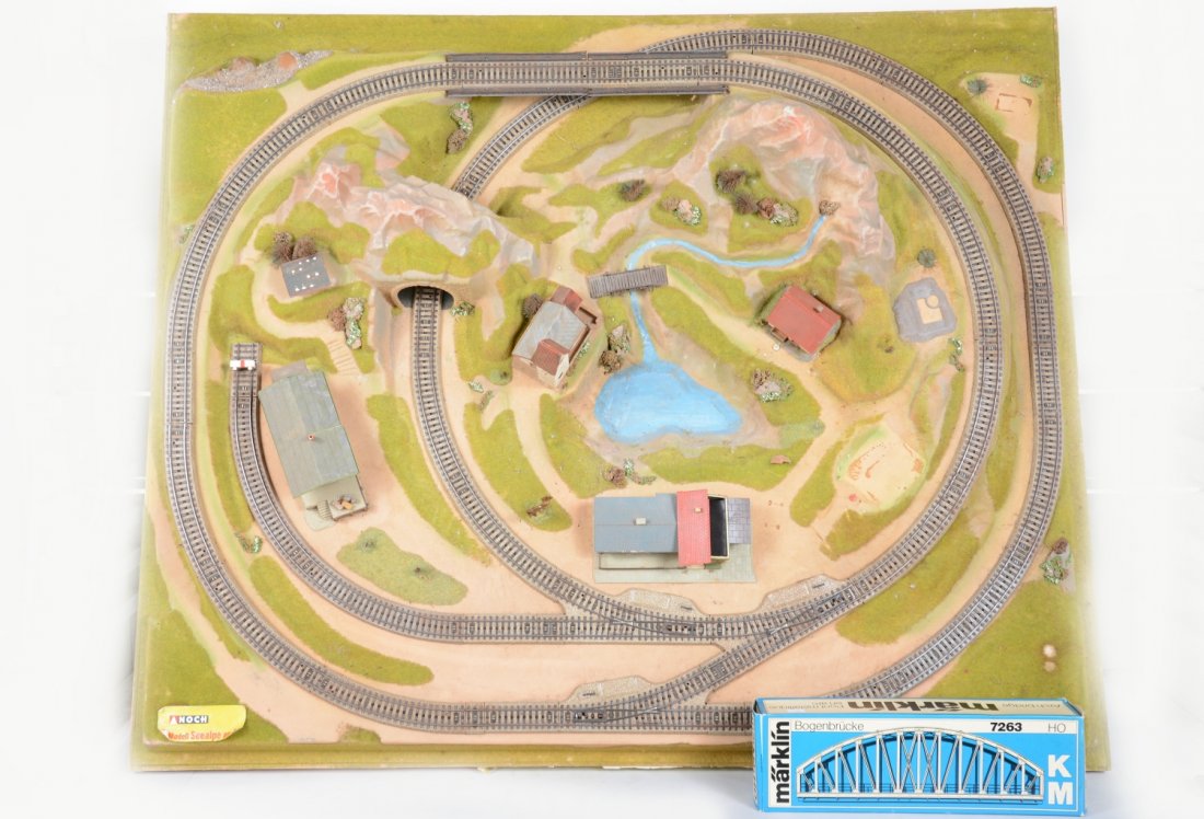 Marklin Noch Layout: 38 X 41 1/2" Noch Layout. It is vacuform plastic with a wood frame It was sold by FAO Schwarz to run Marklin HO 3-rail trains on. A few houses need TLC & some are missing. The layout is sound with no 