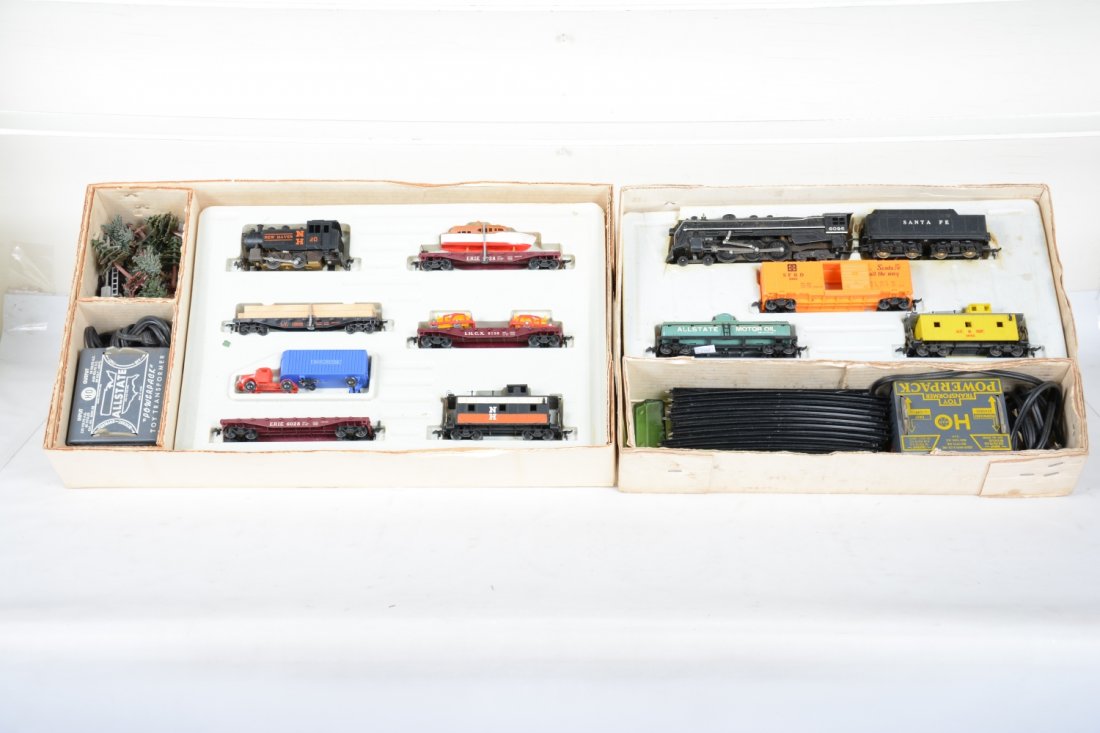 2 Boxed Marx HO Train Sets: Includes #79542 with a smoking SF Hudson with 3 freight cars, track & transformer; Allsate Sears set 9830 with NH tank loco with deluxe freight cars, note dozers are missing their treads. With track,