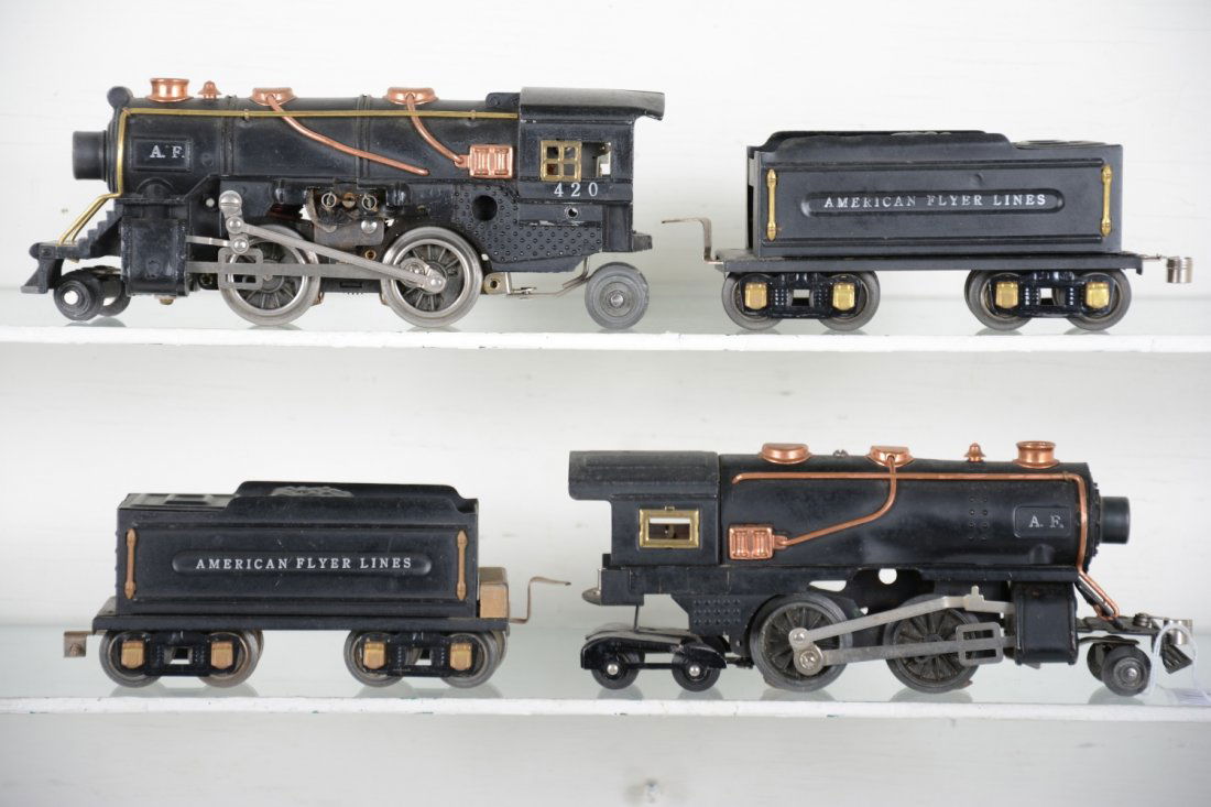 American Flyer Double-Header Steam Locomotives: Circa 1939. Includes a 420 cast 2-4-2 loco with 3189 tender, curly-que coupler; Scarce 428 dummy loco with front curly-que coupler with 421 tender missing link coupler. They show light playwear, C7+