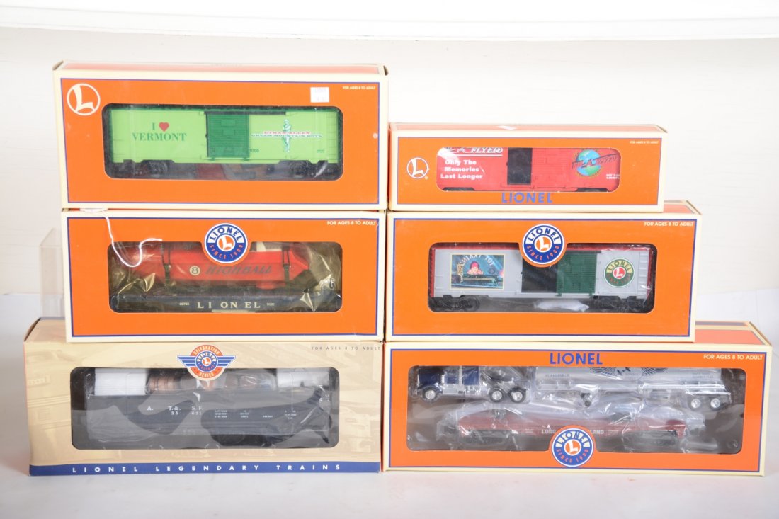 Lionel Freight Cars: Includes 26757 Celebration black barrel car; 52296 Nassau LI flat with tank truck; 19969 Vermont boxcar; 16275 Radio Flyer boxcar; 26785 flat with power boat; 36265 Angela Trotta's Boxcar. All are fac