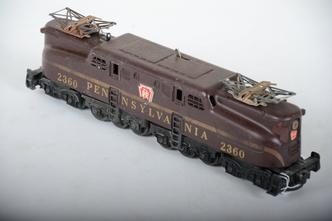 Scarce Lionel 2360 PRR GG1 Electric: Circa 1958 with un-even ventilators. It shows moderate playwear with pantographs missing insulators, missing coupler shoes. C5+-6
