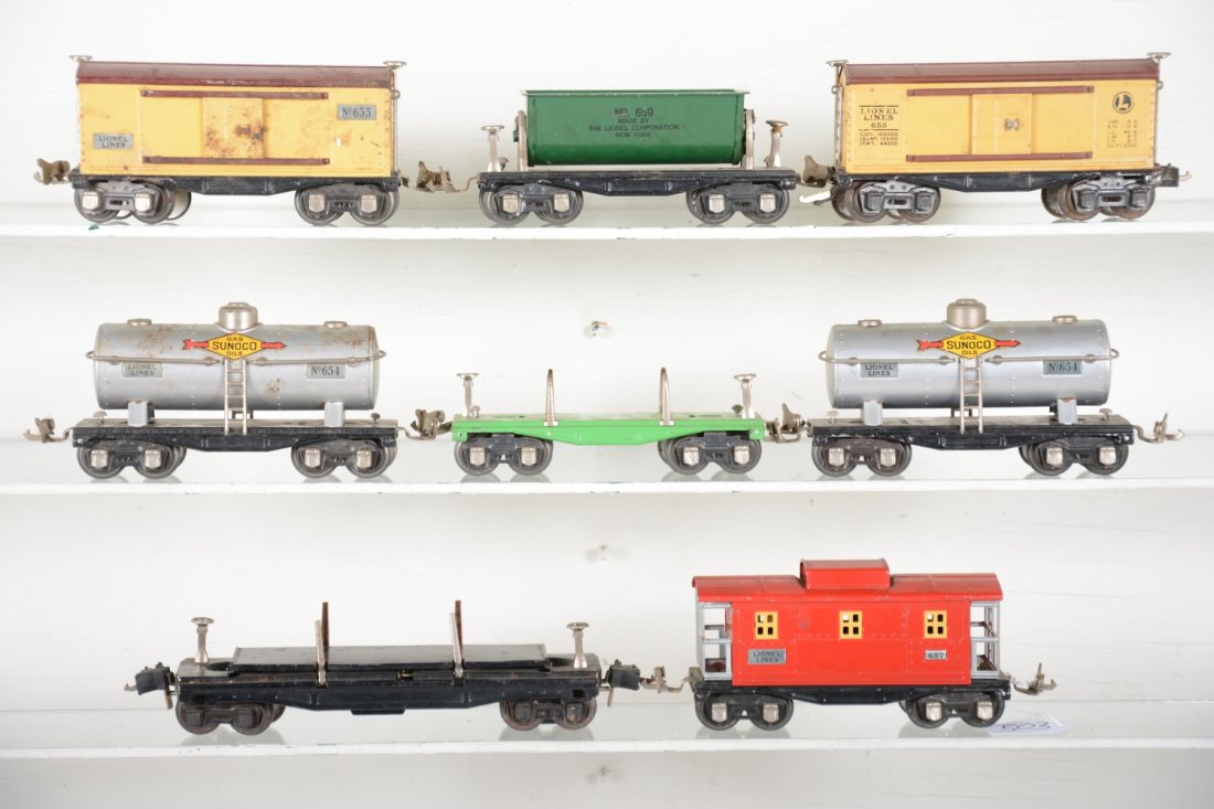 8 Lionel Freight Cars: Includes a 3851 dump car, high couplers; 2 #654 Sunoco tank cars; 659 tipple car; 651 lumber car, no load; 655 boxcar, C4; 657 caboose. Rest should clean up nicely and show moderate playwear, C6-7